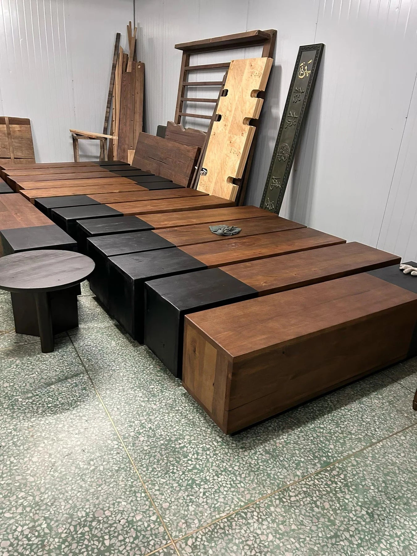 A real workshop batch of timber bed structures arranged for production checks