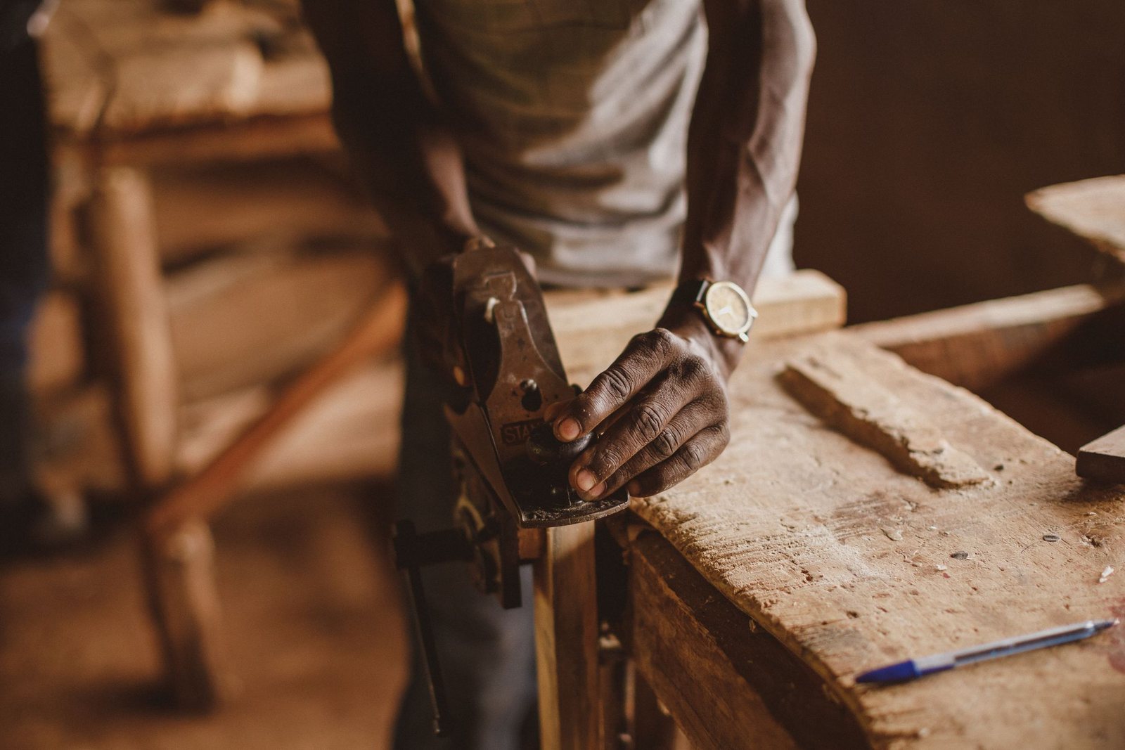 Timber being shaped by hand with a traditional plane