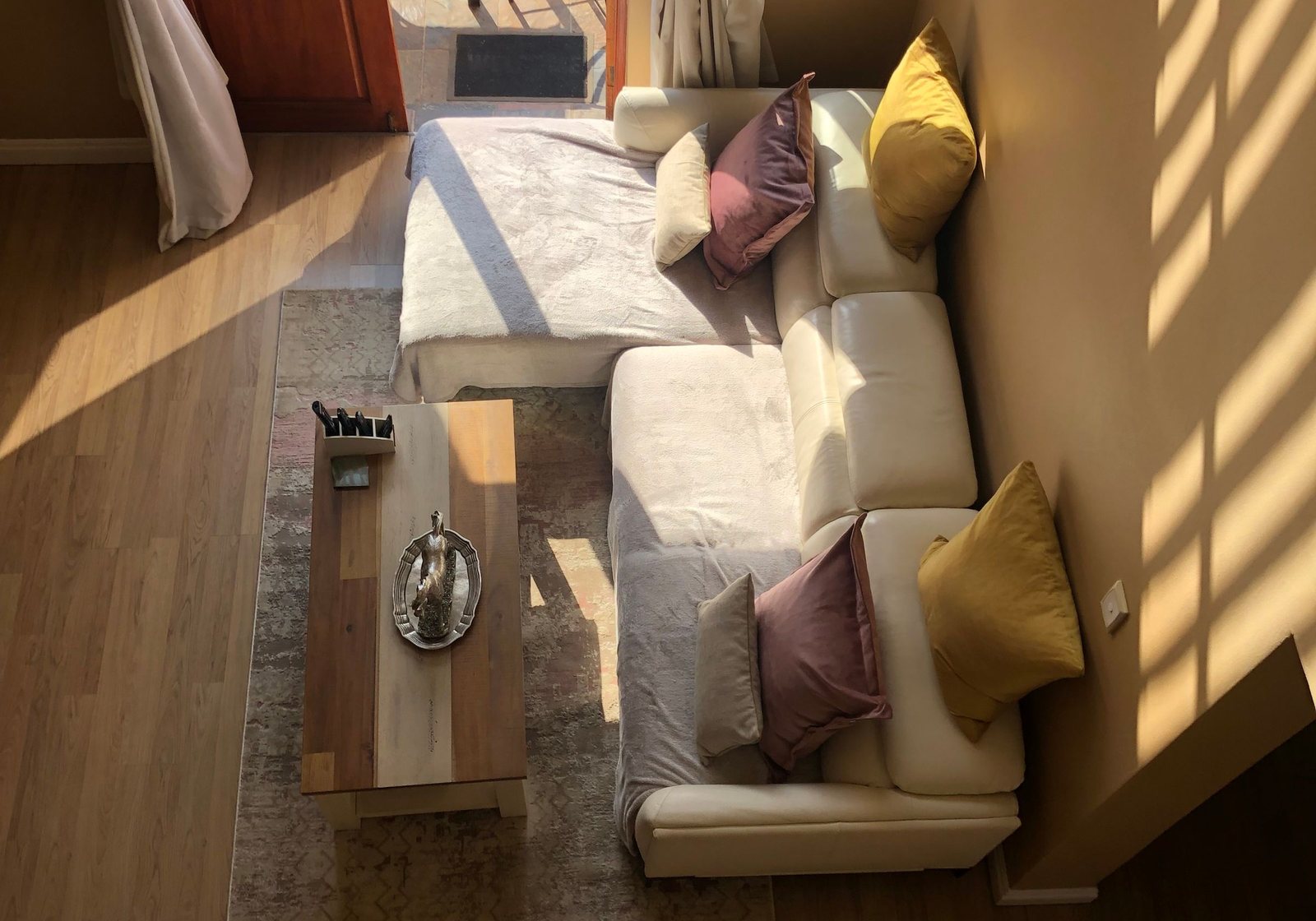 Natural light falling across a warm wooden coffee table in a calm living room