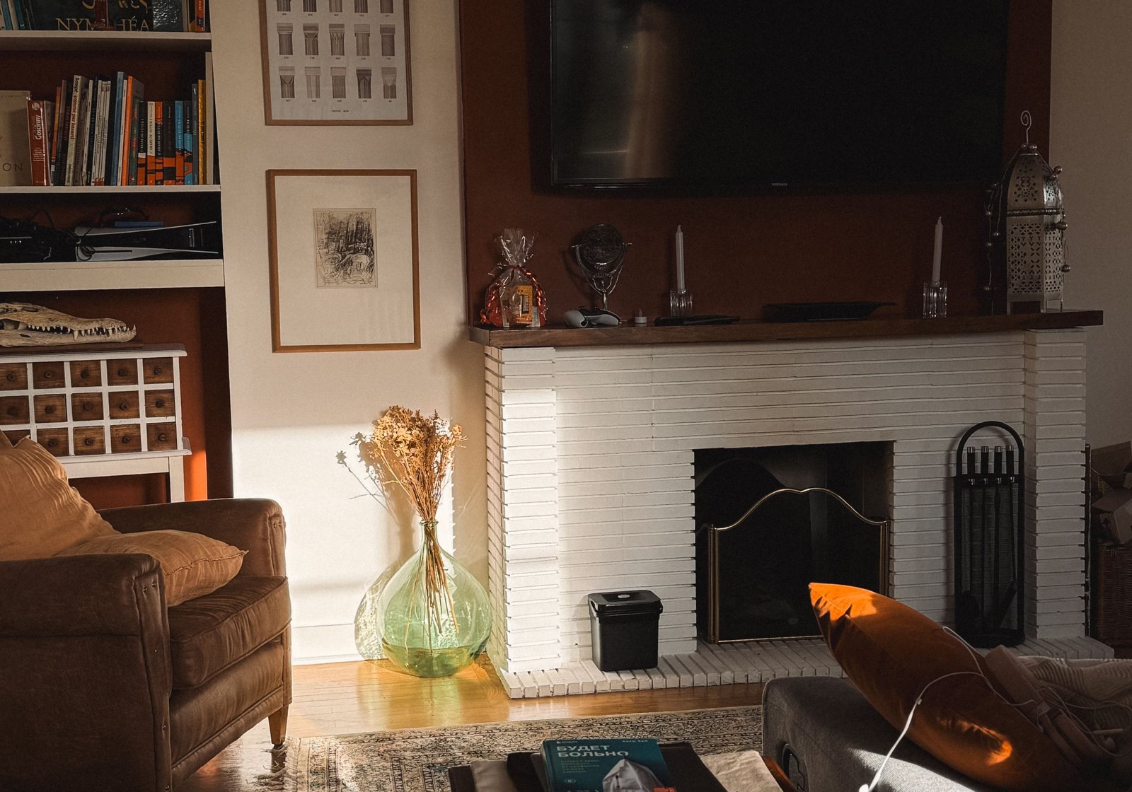 Warm British room with fireplace, timber furniture and layered natural light