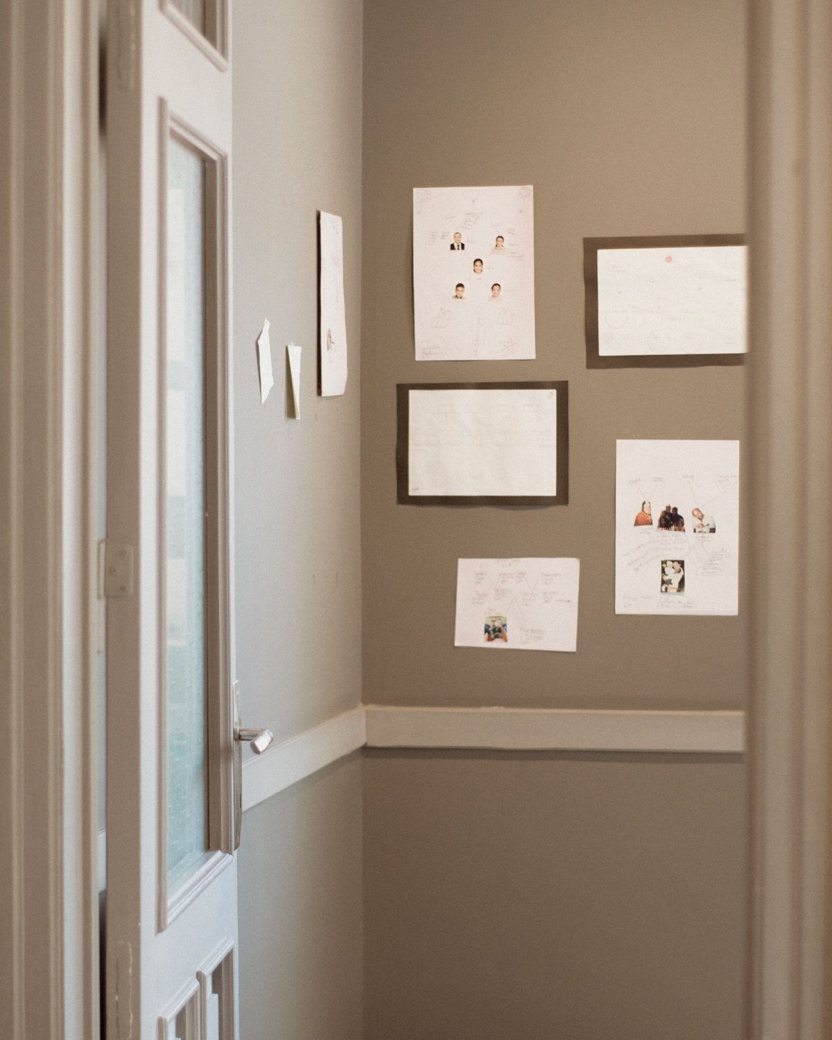 Neutral wall art arranged in a quiet hallway
