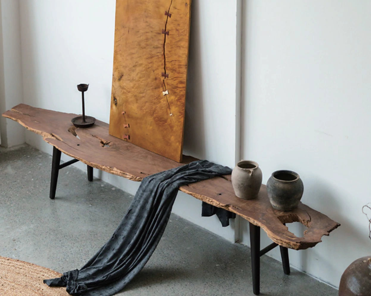 Long live-edge timber bench with dark metal legs