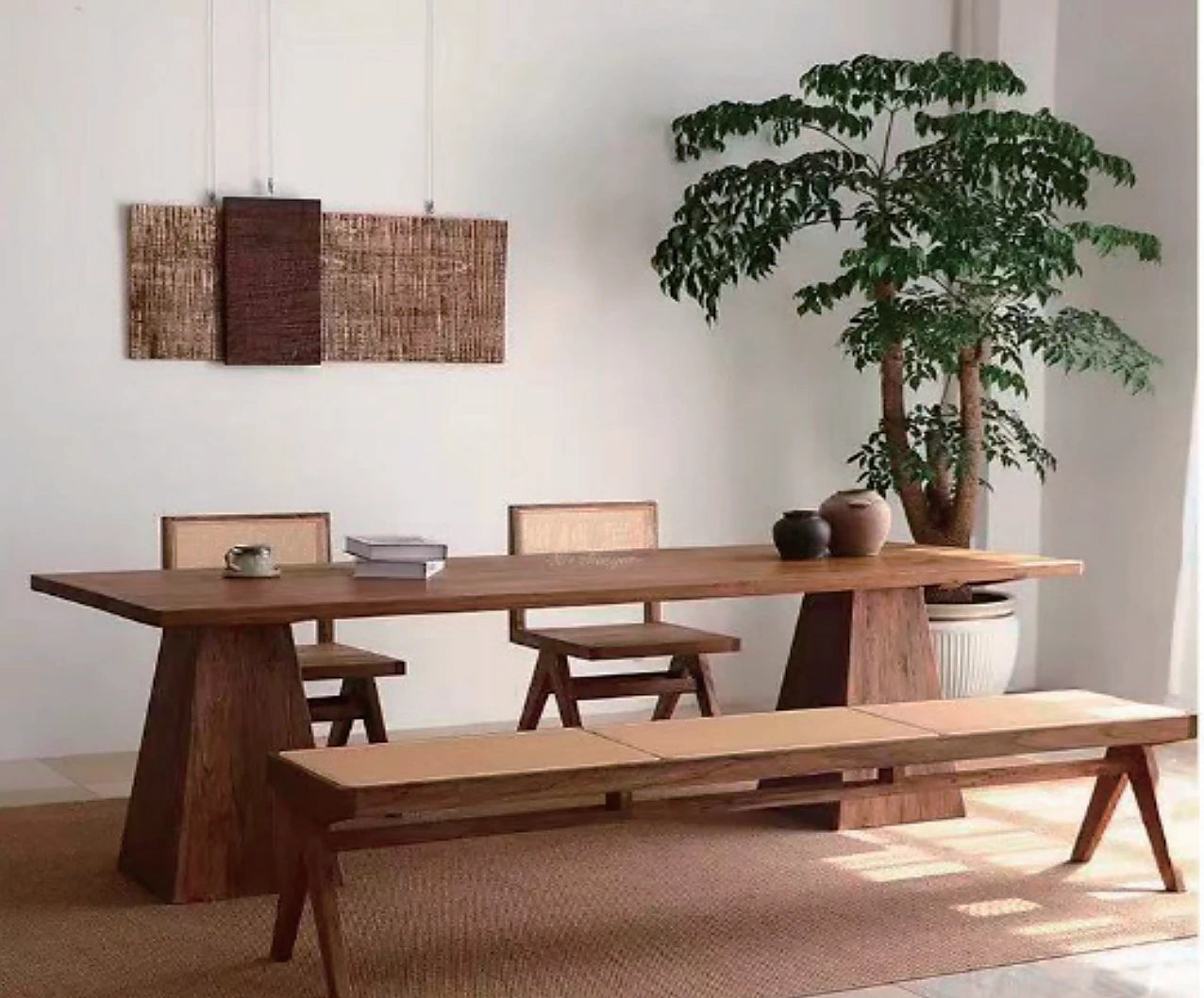 Sculptural solid timber dining table and bench in a calm interior
