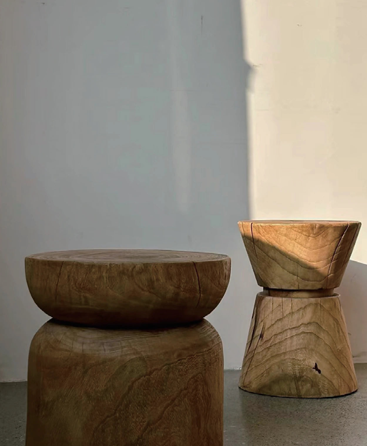 Carved timber side tables with natural grain